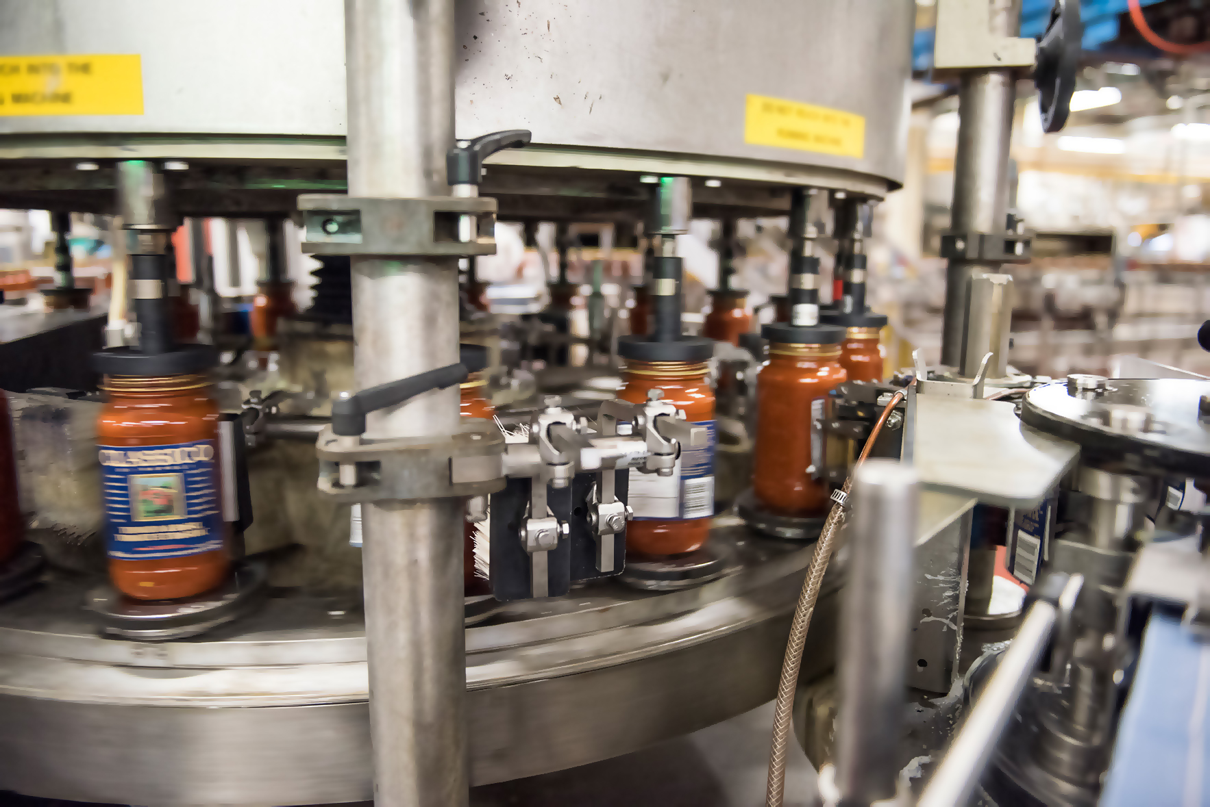 Jars on a conveyour filled with sauce